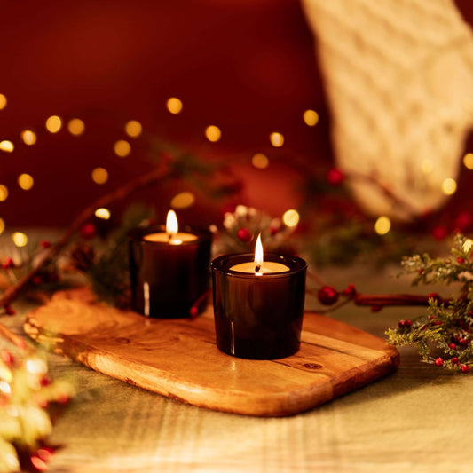 beeswax votive candles burning in dark amber glass votive holders festive christmas decor votives and candles