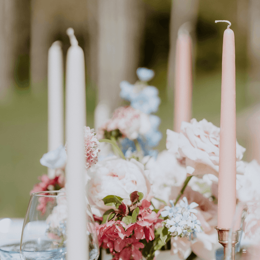 Bluecorn Beeswax hand-dipped beeswax taper candles in Ivory and Dusty Rose on a gorgeous outdoor wedding display in the mountains of Colorado