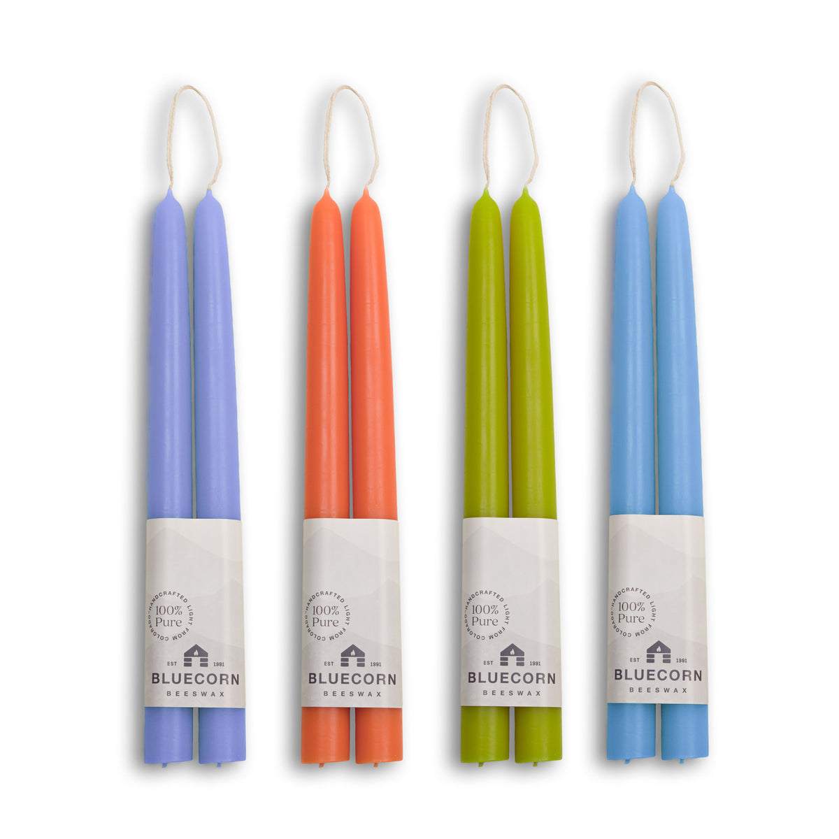 Summer beeswax taper candles bundle in lilac, apricot, pistachio, and sky blue colors.