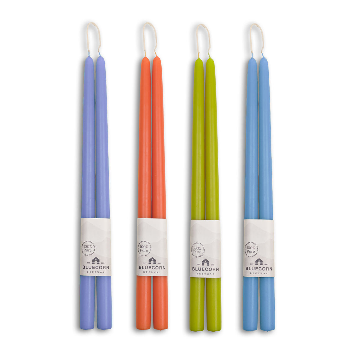 Summer beeswax taper candles in Lilac, Sky Blue, Pistachio, and Apricot colors for vibrant table settings.