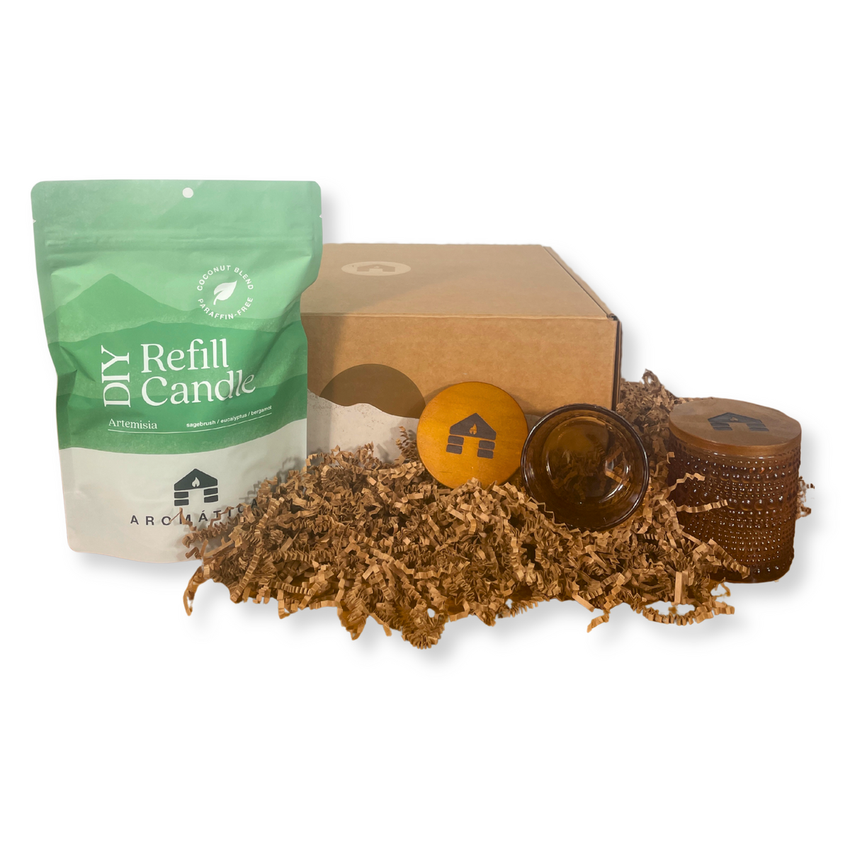 Artemisa scented DIY candle refill kit with packaging, candle wicks, and a glass container on a white background.