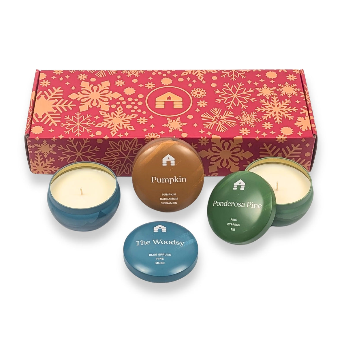 Scented candle gift set featuring three colored candle tins: Pumpkin, Ponderosa Pine, and The Woodsy in a festive box. ideal candles for xmas