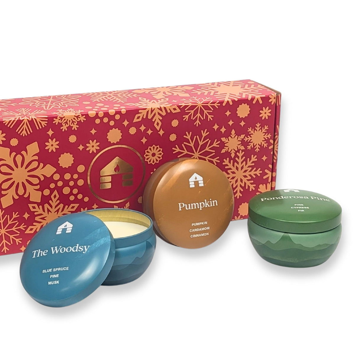 Scented candle gift set featuring three 8oz tins: Pumpkin, The Woodsy, and Ponderosa Pine in a festive red box.