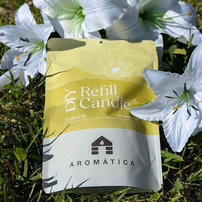 White Lily scented Bluecorn Aromática DIY refill kit lying in grass with lily flowers