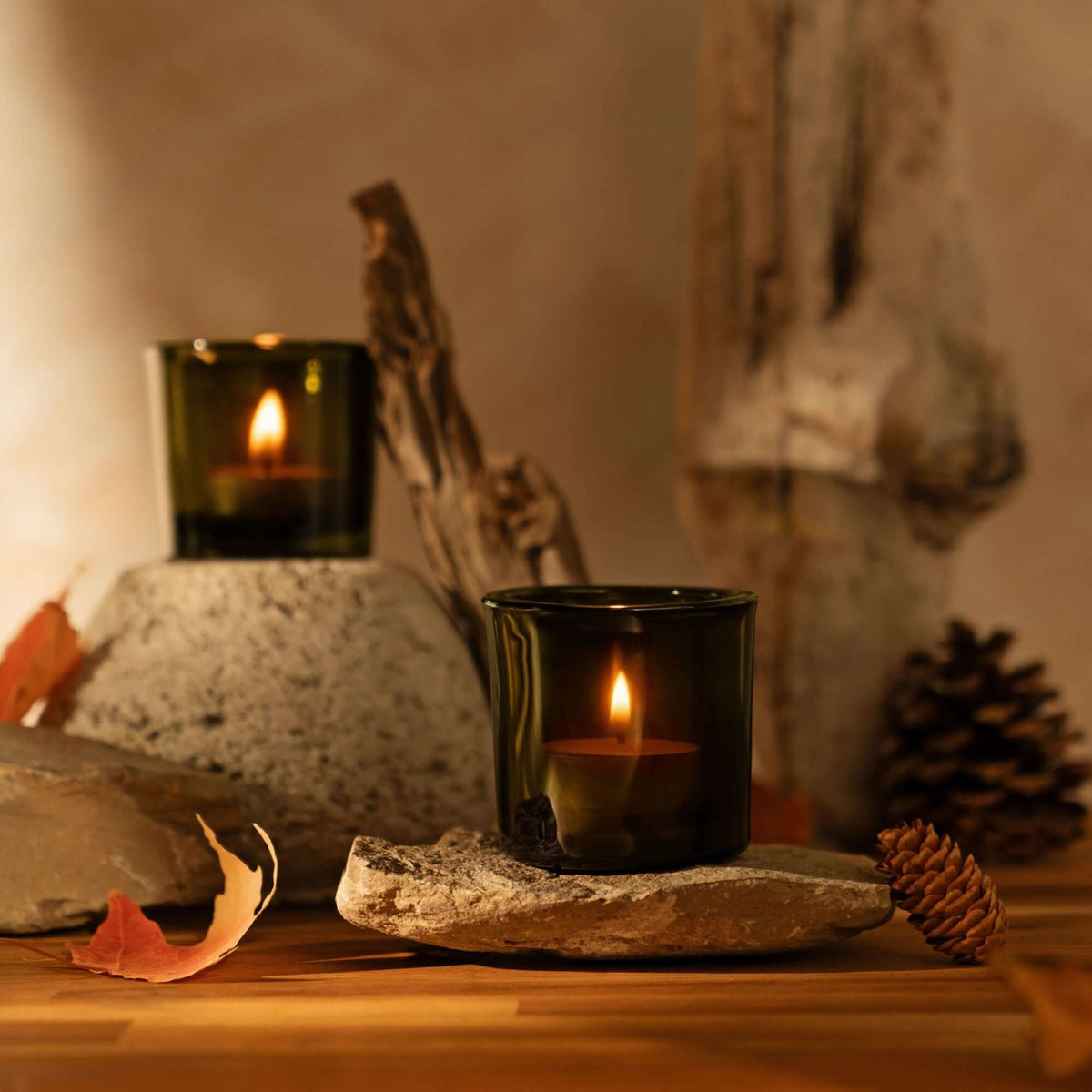 tea light candles burning in Vintage Green heavy glass votive holders with fall decor background