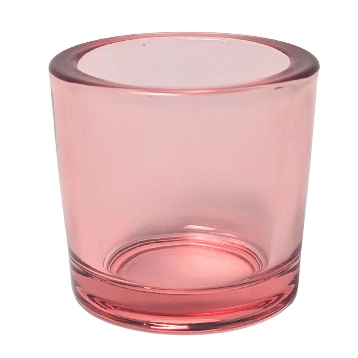 Pink glass votive candle holder on a white background
