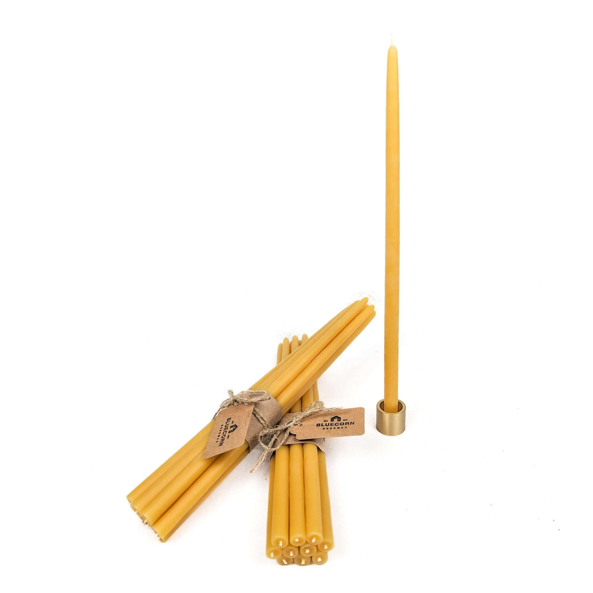 Raw thin beeswax taper in a solid brass thin taper candle holder