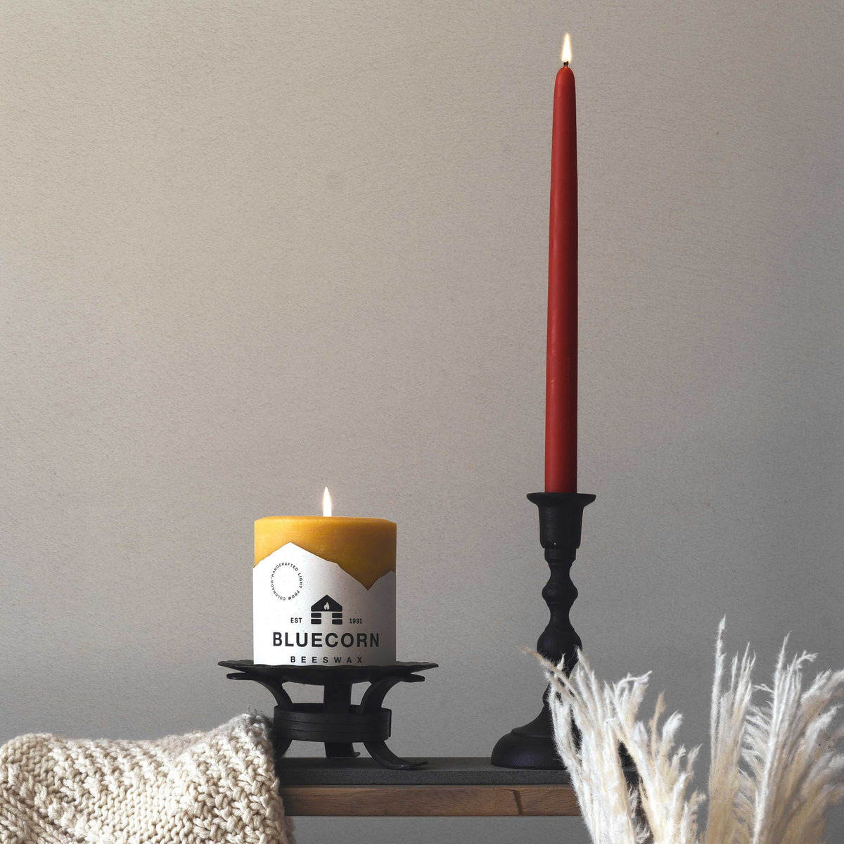 burgundy beeswax taper candles next to bluecorn beeswax pillar