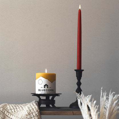 burgundy beeswax taper candles next to bluecorn beeswax pillar