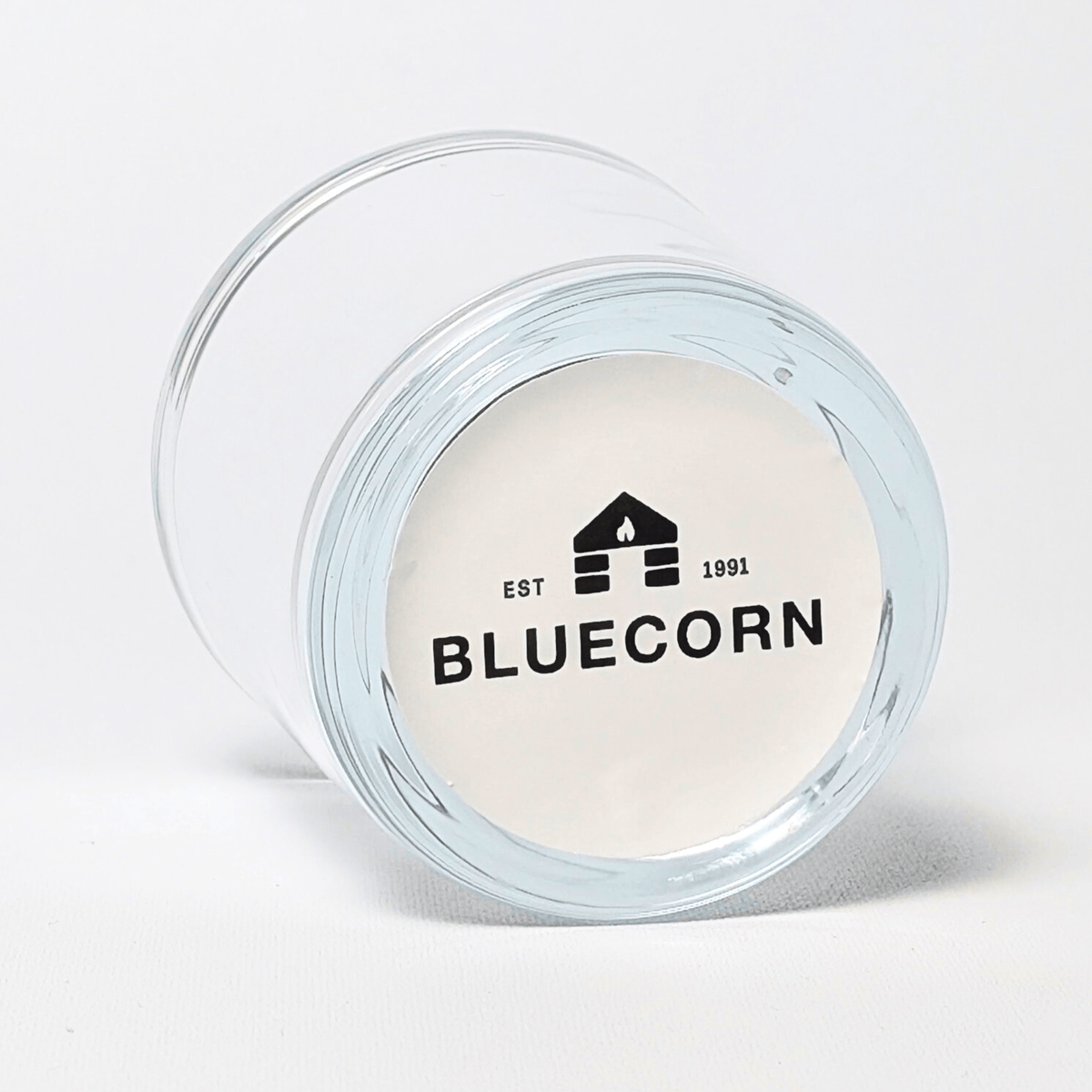 Clear glass votive candle holder made of 50% recycled glass with Bluecorn sticker on the bottom