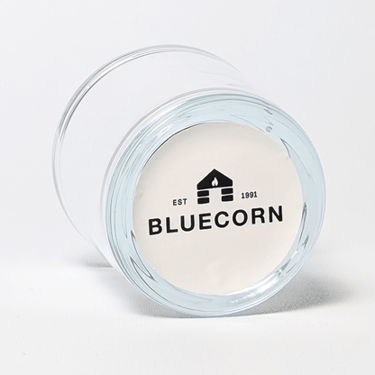 Clear glass votive candle holder made of 50% recycled glass with Bluecorn sticker on the bottom