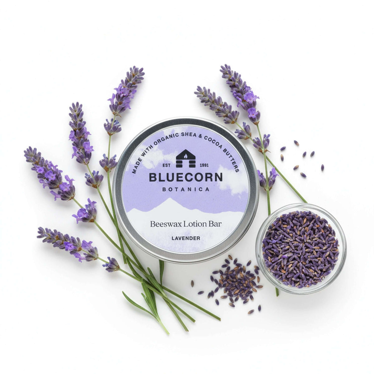 Bluecorn Botanica Beeswax Lotion Bar in Lavender. Made with Organic Shea Butter, Organic Cocoa Butter, Avocado Oil, Apricot Oil, Cappings Beeswax, Essential Oils. Using the warmth of your hands, these solids bars will turn into lotions. Can be used all over the body and come in a convenient tin. Features Purple Bluecorn Botanica Label on aluminum tin. 