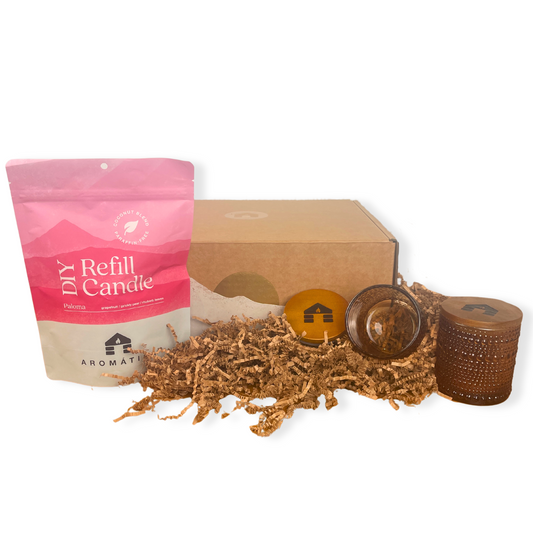 Paloma scented DIY candle refill kit with packaging, candle wicks, and a glass container on a white background.