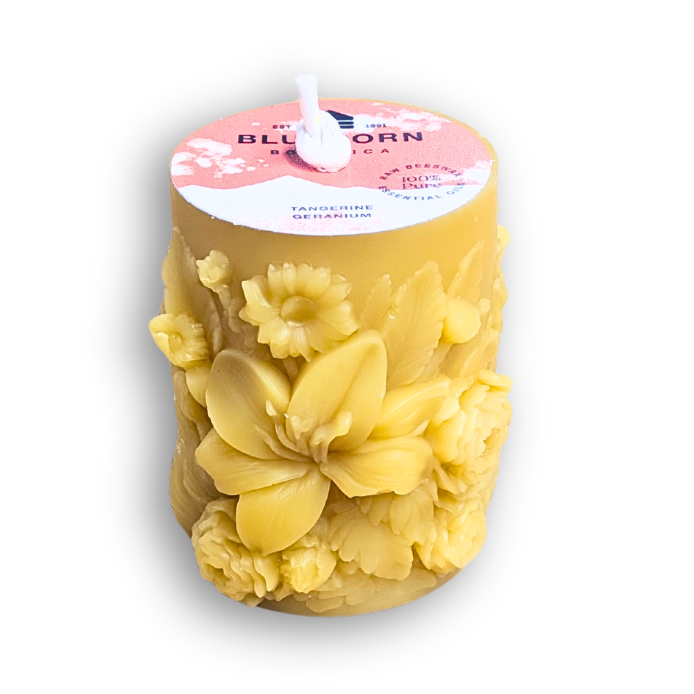 beeswax pillar candle with sculptural floral motif scented with tangerine and geranium essential oils great for gifting