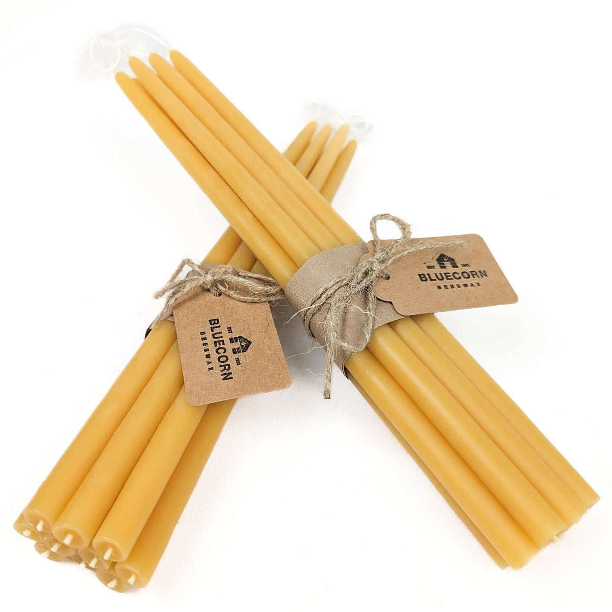Two bundles of raw thin beeswax taper candles