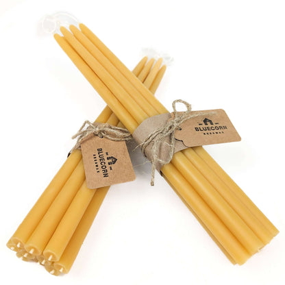 Two bundles of raw thin beeswax taper candles