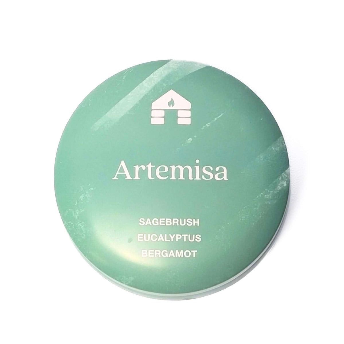 The top of a Bluecorn Aromática 8oz Artemisa scented candle tin with white background