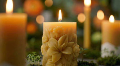 decorative floral beeswax pillar candle with other beeswax pillars and tapered candles in the background