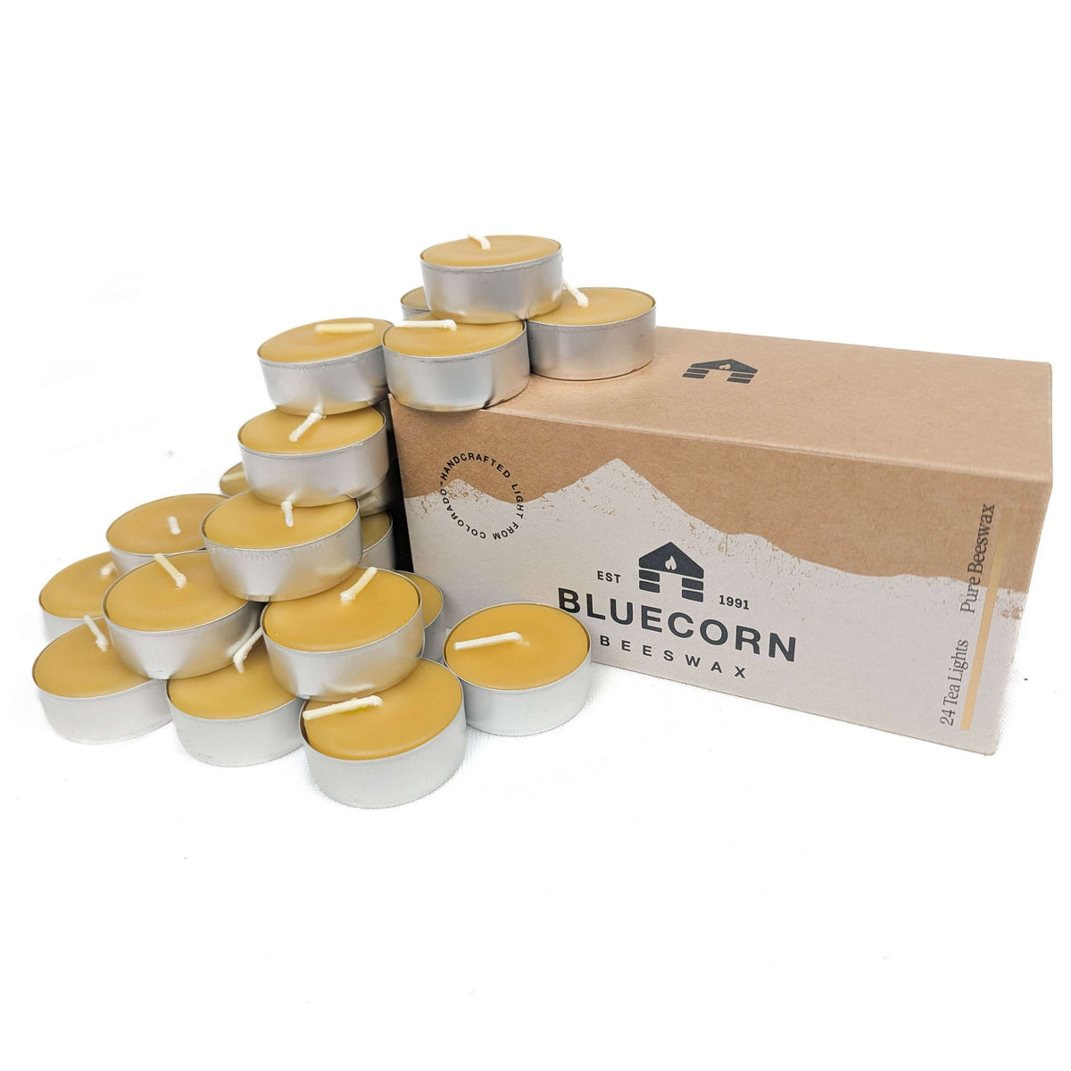 Bluecorn Beeswax 24-pack pure beeswax tea light candles in metal cups with bluecorn branded box and raw beeswax tea lights stacked around the box