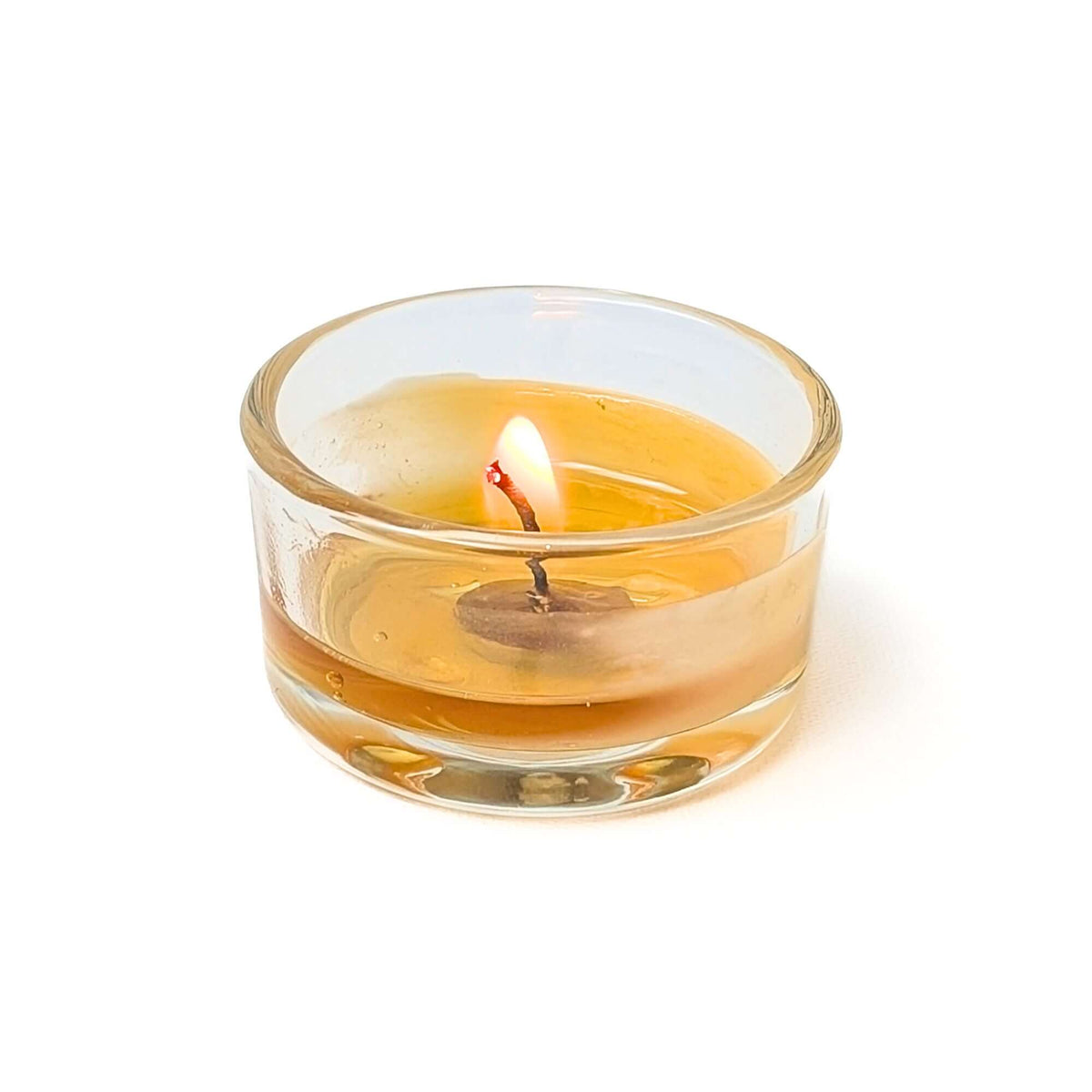 bees wax tea light burning perfectly in glass candle holder