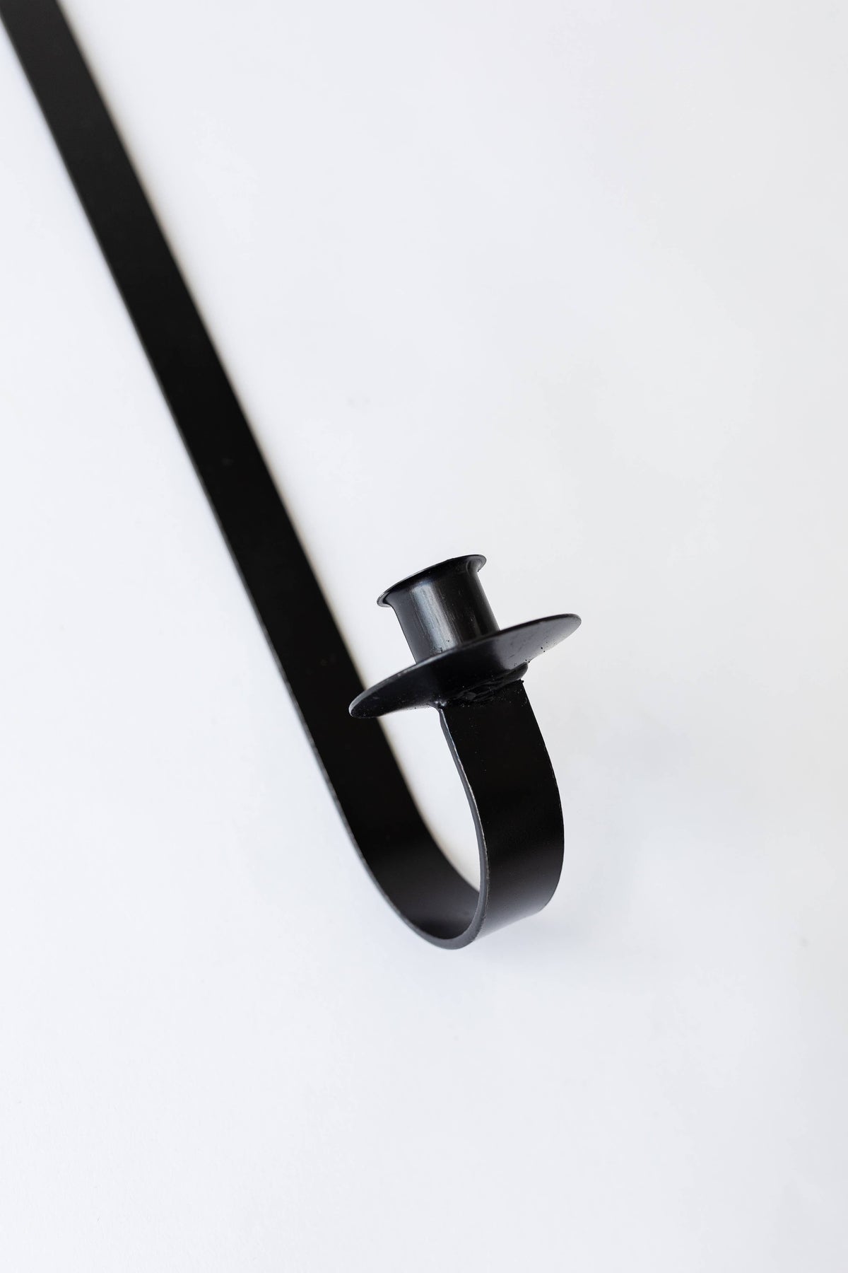closeup of black iron taper holder 