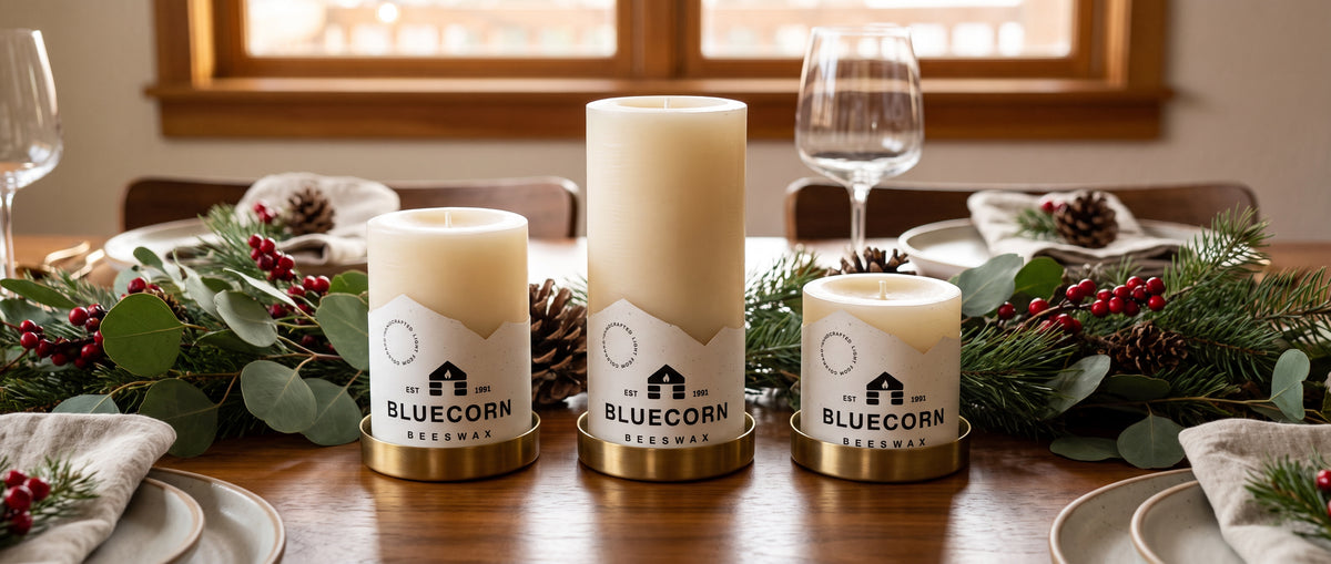 Ivory beeswax pillar candle trio on a Christmas-themed table