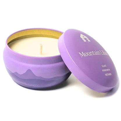 A Bluecorn Aromática 8oz Mountain Lilac scented candle tin with the lid taken off showing the wick and wax with white background