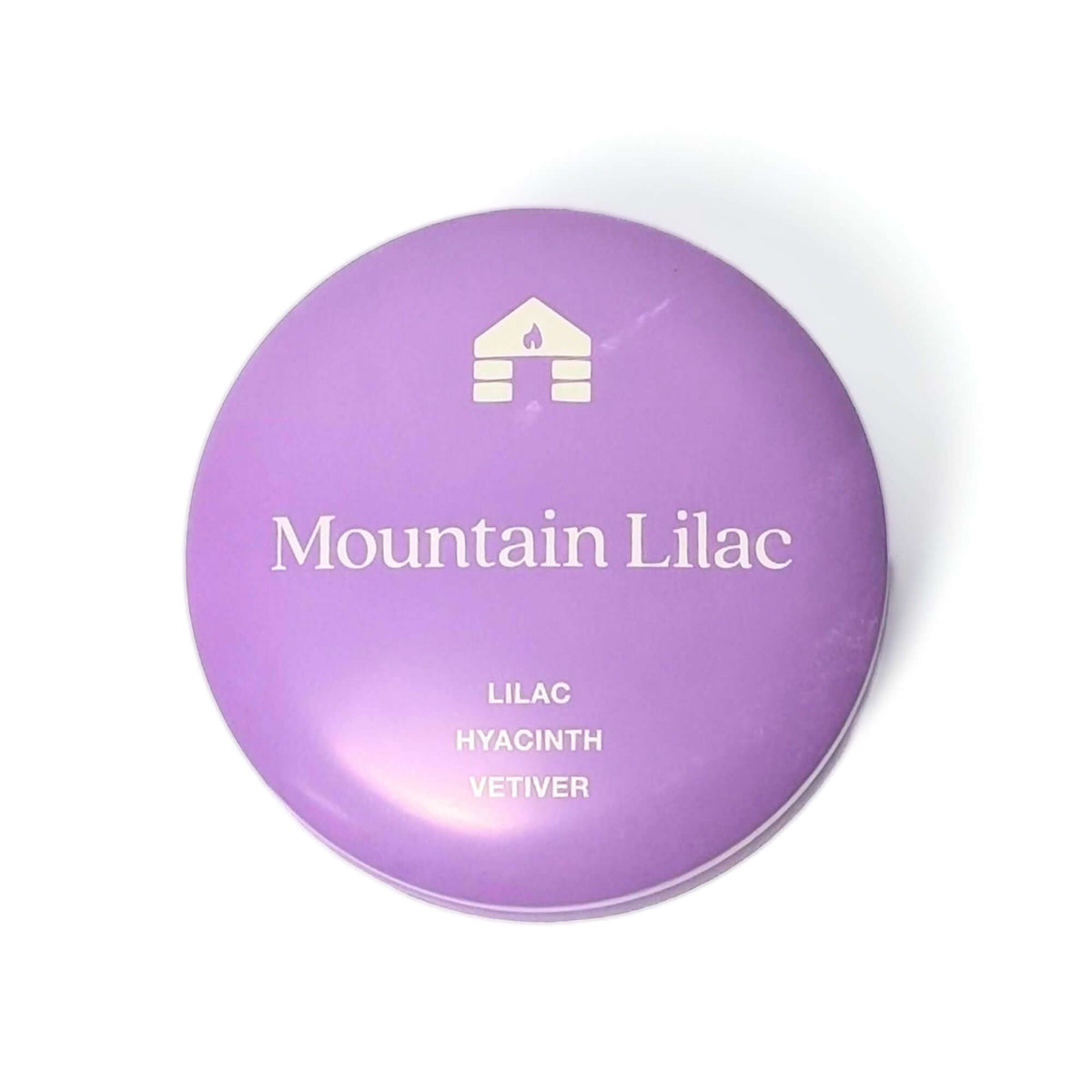 The top of a Bluecorn Aromática 8oz Mountain Lilac scented candle tin with white background