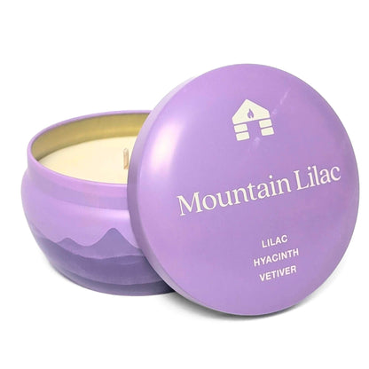 A Bluecorn Aromática 8oz Mountain Lilac scented candle tin with the lid taken off showing the wax with white background