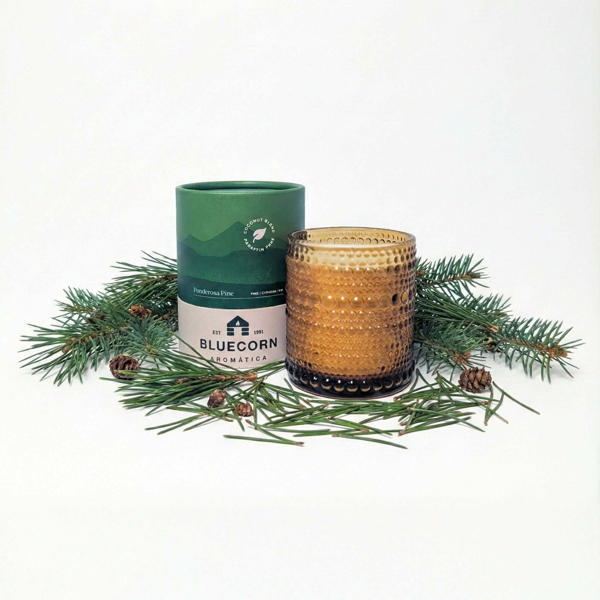 Ponderosa Pine candle in a bed of pine needles