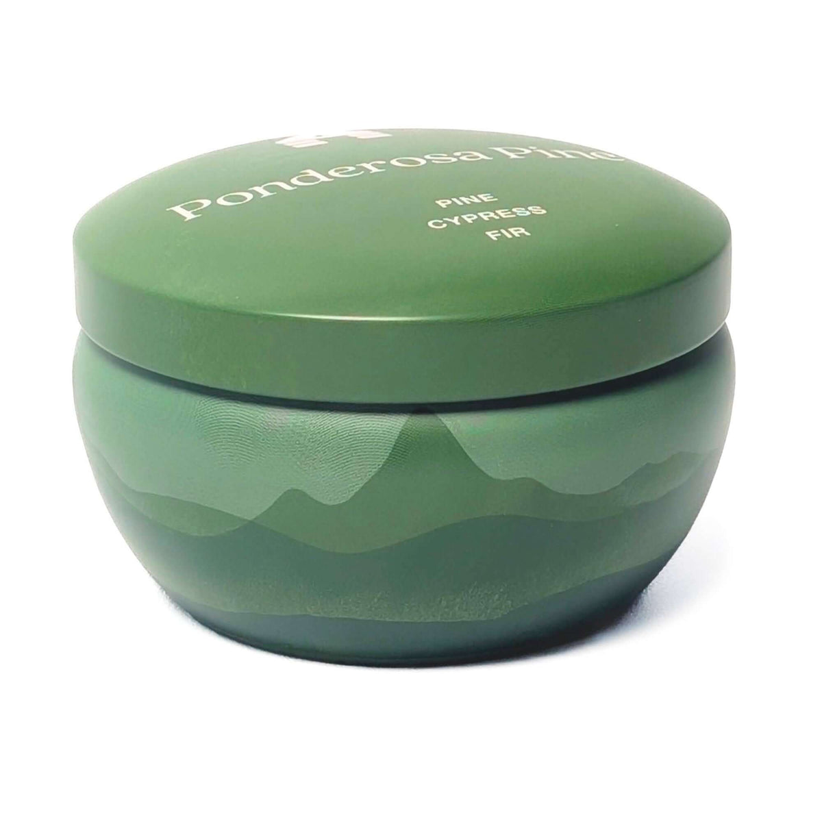 The side of a Bluecorn Aromática 8oz Ponderosa Pine scented candle tin with white background