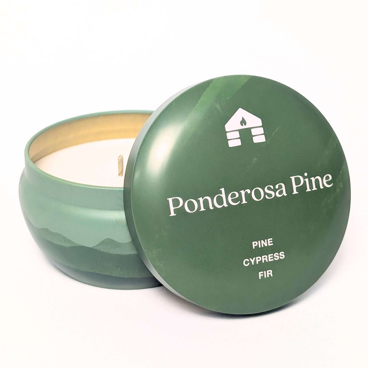 A Bluecorn Aromática 8oz Ponderosa Pine scented candle tin with the lid taken off showing the wax with white background