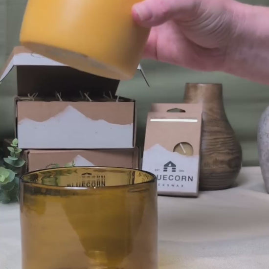 A 9 second video demonstrating a refill candle being put into a amber glass candle jar