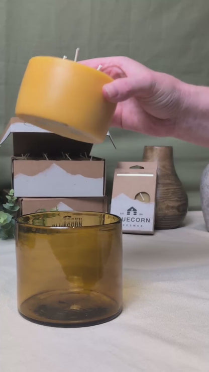 A 9 second video demonstrating a refill candle being put into a amber glass candle jar