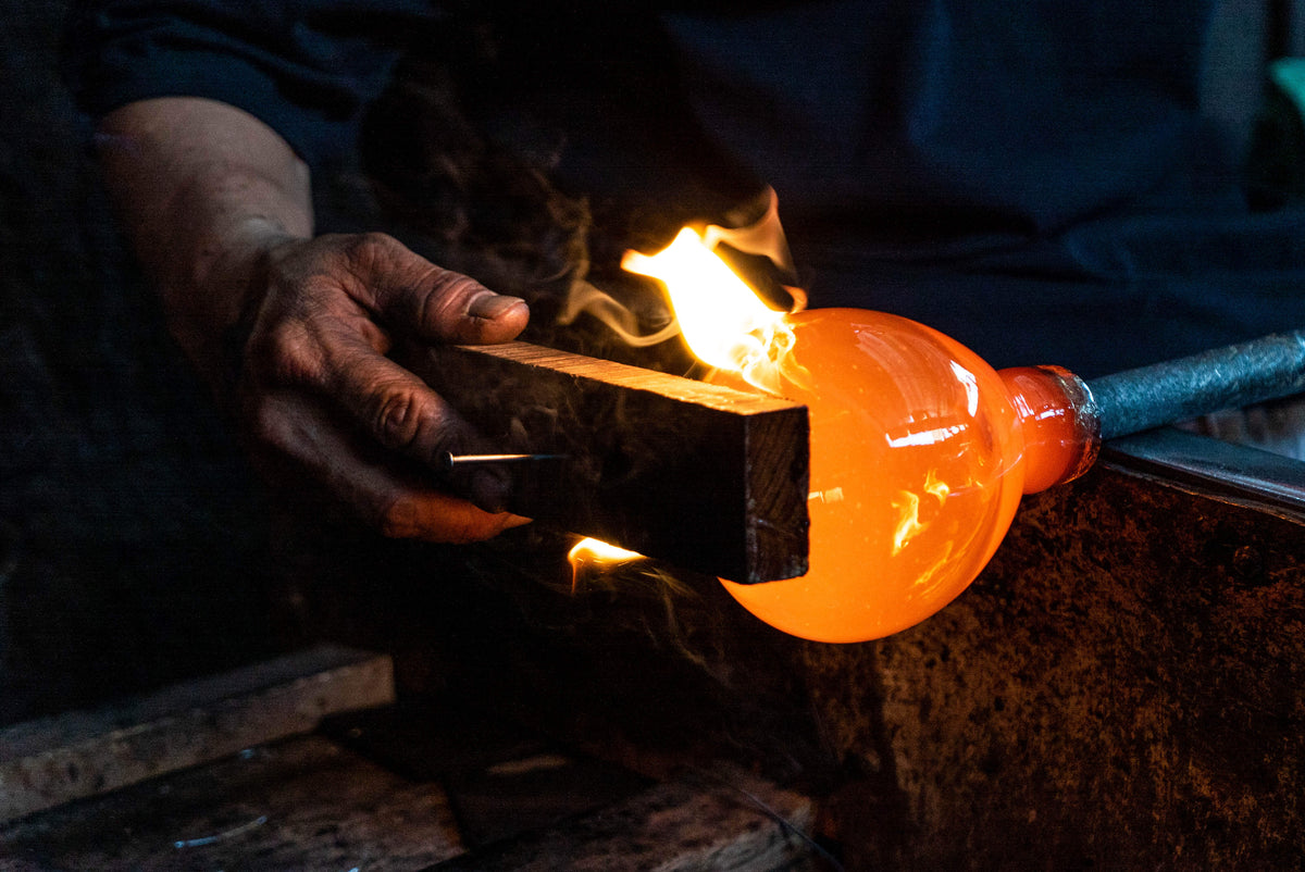 Load video: A gorgeous video depiction the artisan glass blowing process used to make Bluecorn's 100% recycled glass candle holders