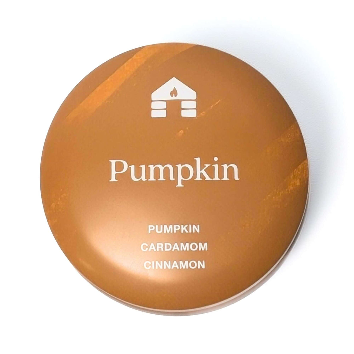 The top of a Bluecorn Aromática 8oz Pumpkin scented candle tin with white background