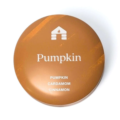 The top of a Bluecorn Aromática 8oz Pumpkin scented candle tin with white background