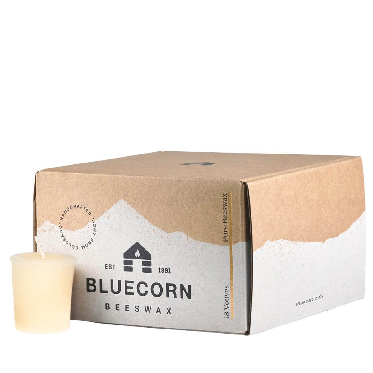 A single beeswax votive candle in the color ivory, sitting next to a closed 18-pack votive box