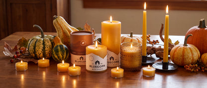 pumpkin scented candle from bluecorn with a wide variety of beeswax candles including tea lights, tapers, votives and pillars on a thanksgiving fall decor themed dining table 