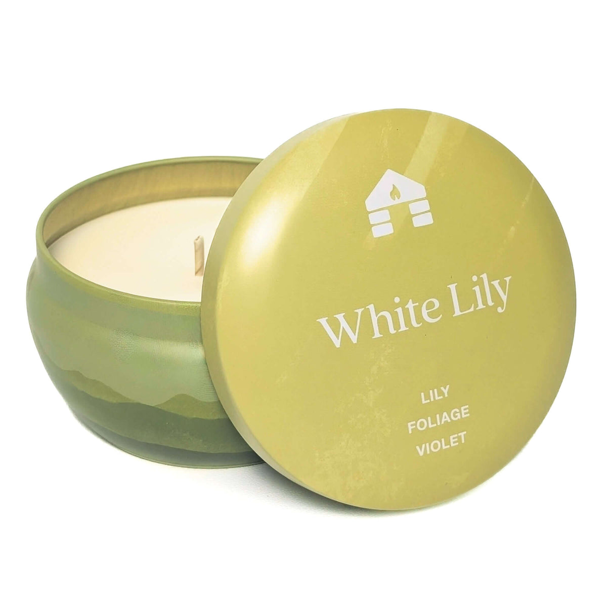 A Bluecorn Aromática 8oz White Lily scented candle tin with the lid taken off showing the wax with white background